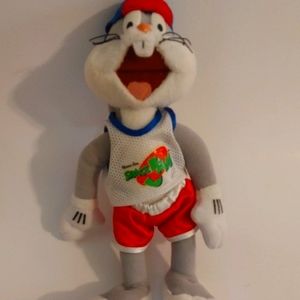 Bugs Bunny wearing basketball shorts backwards hat and Space Jam t-shirt